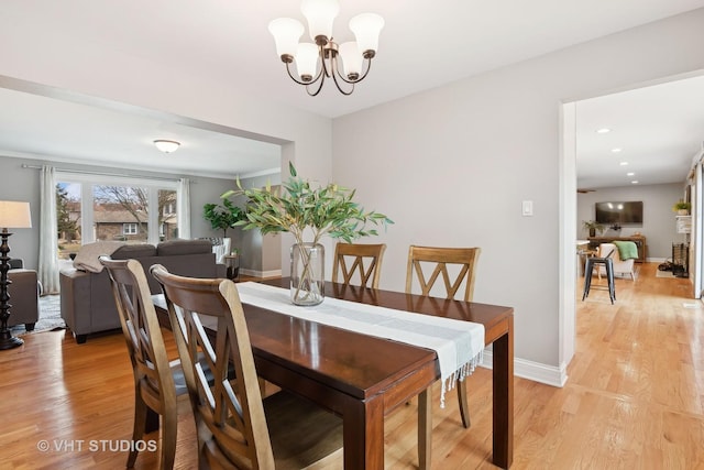 dining room featuring an inviting chandelier and light hardwood / wood-style flooring