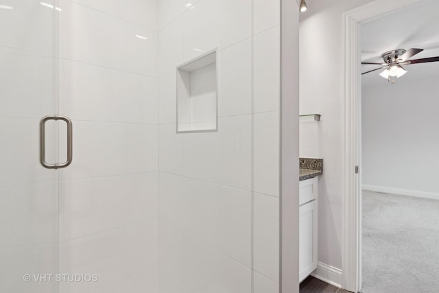 bathroom featuring vanity, an enclosed shower, and ceiling fan