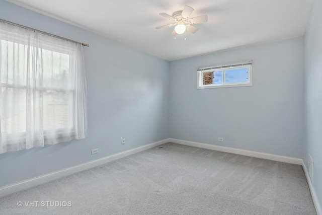 carpeted empty room featuring ceiling fan