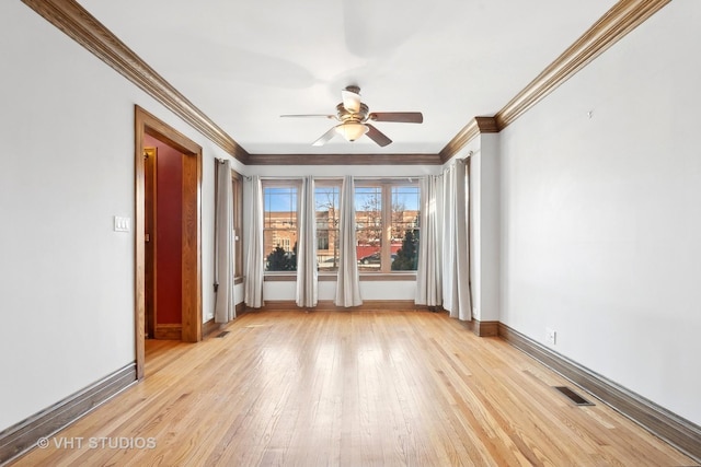 empty room featuring crown molding, ceiling fan, and light hardwood / wood-style flooring