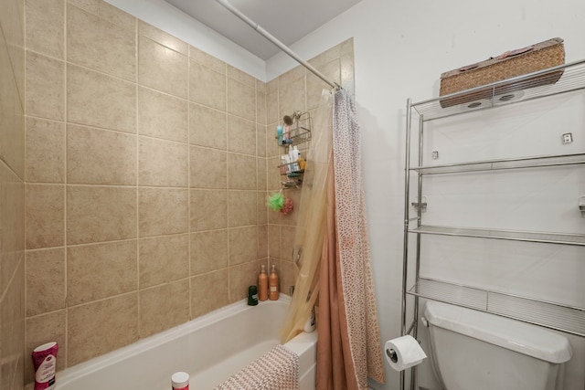 bathroom with shower / tub combo with curtain and toilet