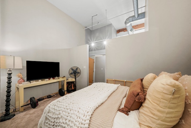 bedroom featuring a high ceiling and carpet