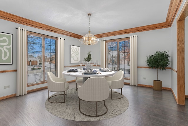 dining room featuring an inviting chandelier, ornamental molding, dark hardwood / wood-style floors, and a healthy amount of sunlight