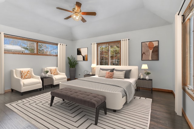 bedroom featuring dark hardwood / wood-style flooring, vaulted ceiling, and ceiling fan