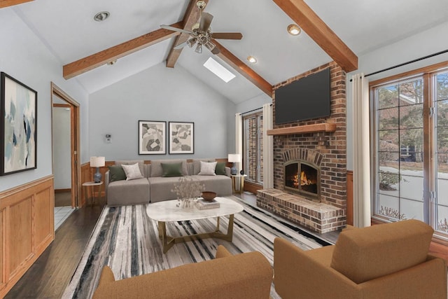 unfurnished room featuring lofted ceiling, wood finished floors, a wealth of natural light, and baseboards