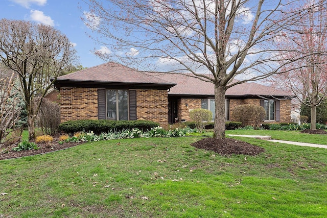 ranch-style home with a front lawn and brick siding