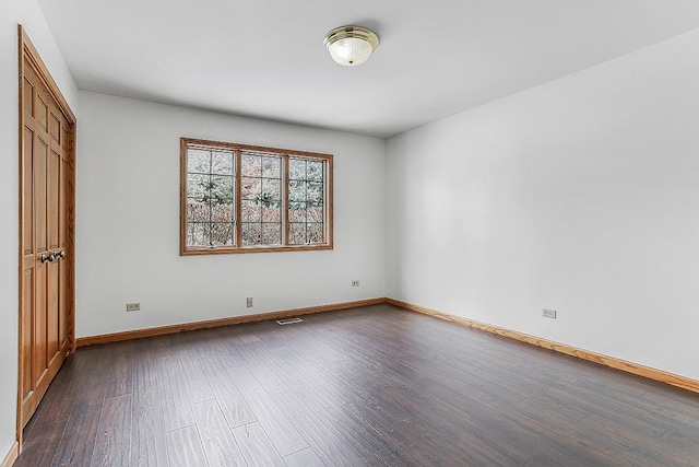 unfurnished bedroom featuring dark wood-type flooring