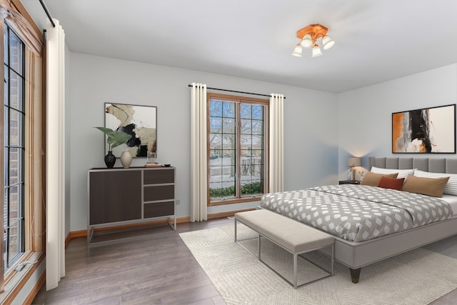 bedroom featuring baseboards and wood finished floors