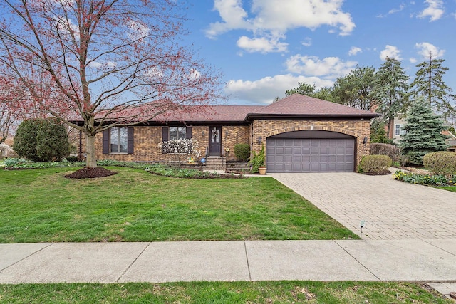 single story home with a garage, brick siding, decorative driveway, and a front yard