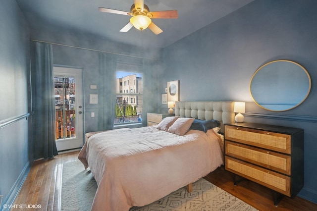 bedroom featuring a ceiling fan, baseboards, and wood finished floors