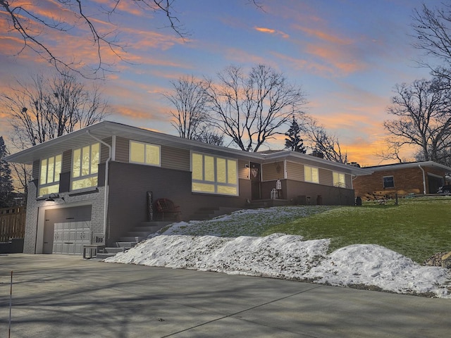 view of front of house with a garage and a lawn