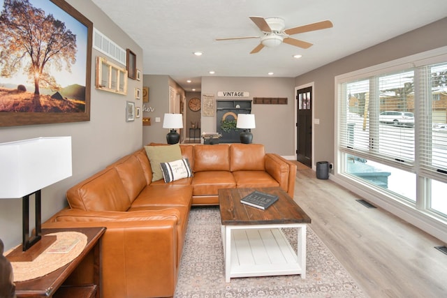 living room with ceiling fan and light hardwood / wood-style flooring