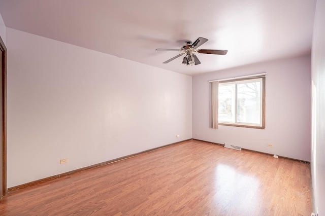 spare room featuring ceiling fan and light wood-type flooring