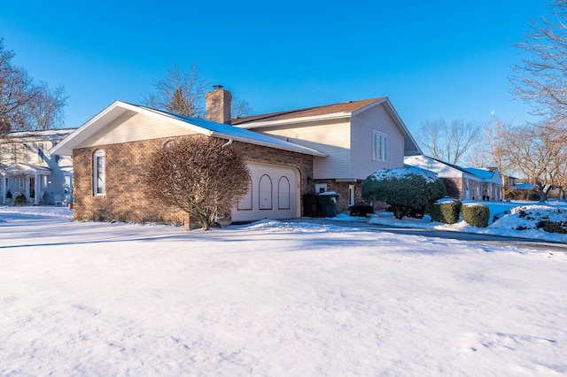 view of snow covered exterior with a garage