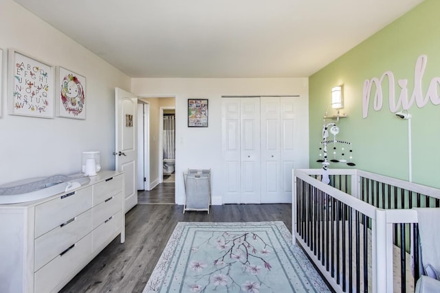 bedroom featuring dark hardwood / wood-style flooring and a closet