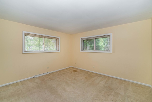 empty room with a healthy amount of sunlight and light colored carpet