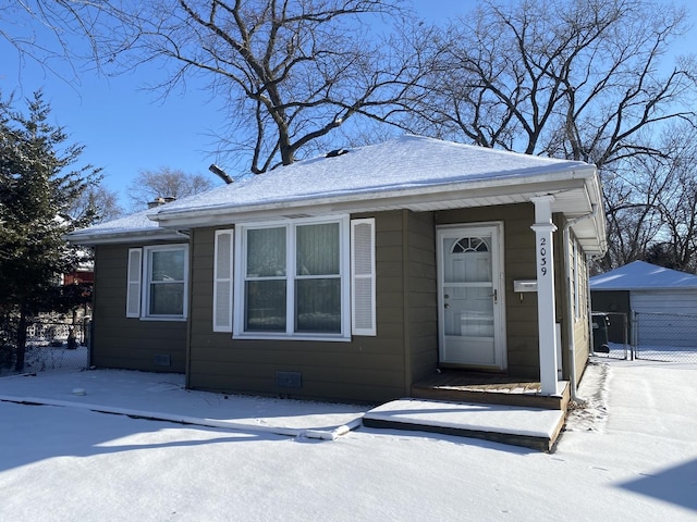 view of front of home with a garage and an outdoor structure