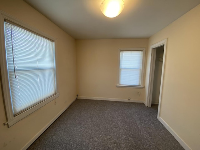 empty room featuring dark colored carpet