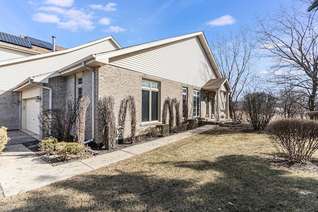 view of property exterior featuring a garage and a lawn