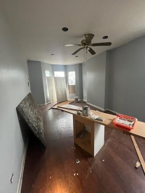 interior space with dark hardwood / wood-style floors and ceiling fan