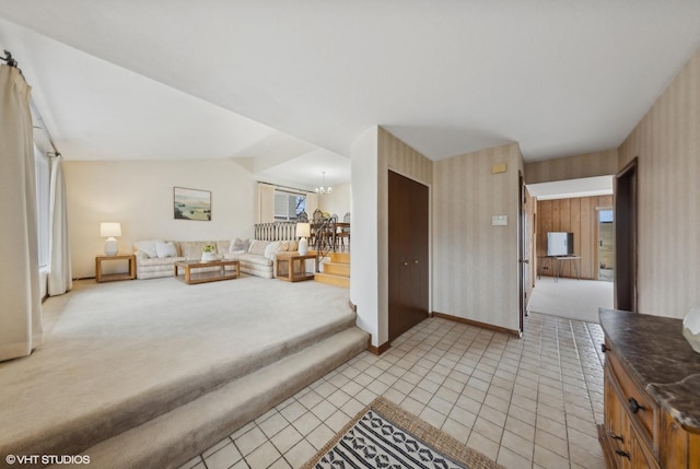 living room with vaulted ceiling, light tile patterned floors, and a chandelier