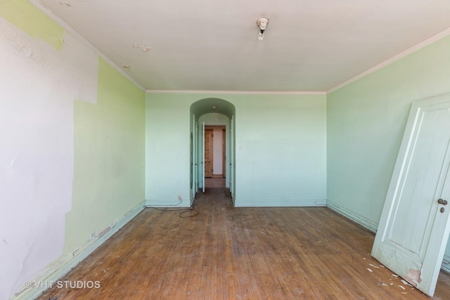 unfurnished room with crown molding and dark hardwood / wood-style floors