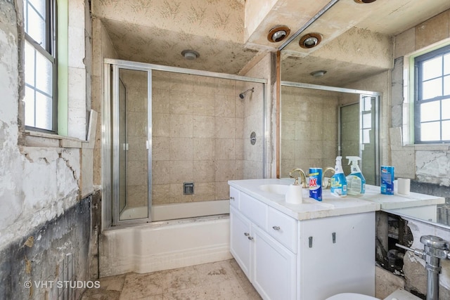 full bathroom with vanity, shower / bath combination with glass door, and toilet