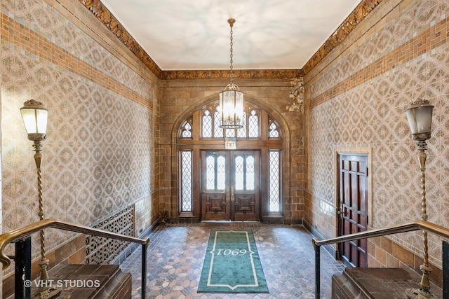 foyer with a chandelier