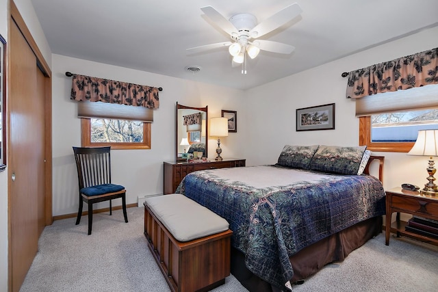 carpeted bedroom featuring ceiling fan and a closet