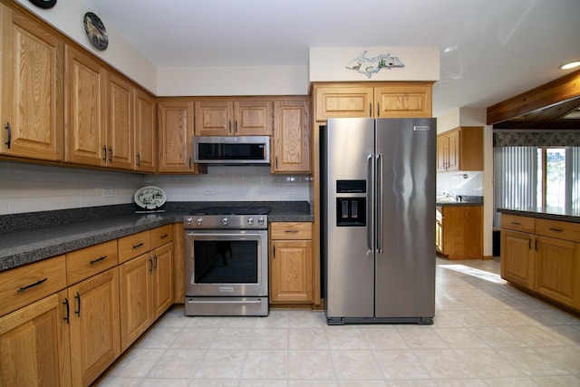 kitchen with backsplash and stainless steel appliances