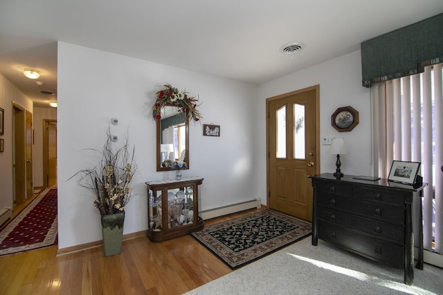 foyer featuring a baseboard radiator and hardwood / wood-style floors