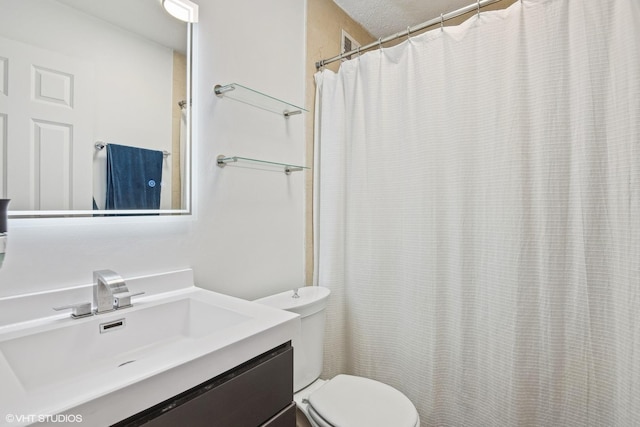 bathroom with walk in shower, vanity, and toilet