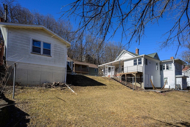 469 Dewey Ave, Galena, IL 61036 - view of home's exterior featuring stairs, a chimney, and a yard