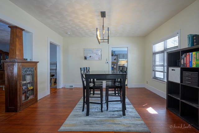 469 Dewey Ave, Galena, IL 61036 - dining room with baseboards, visible vents, dark wood finished floors, and a notable chandelier