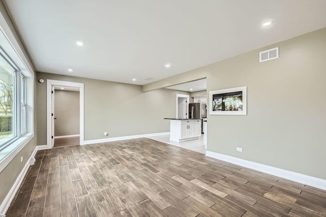 unfurnished living room with light wood-type flooring