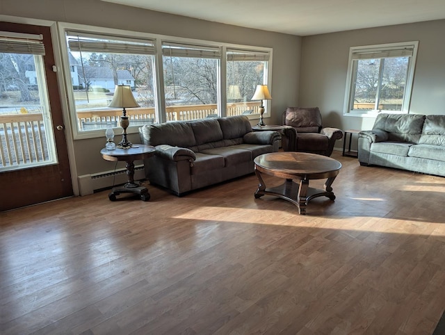 living room with hardwood / wood-style flooring and a baseboard radiator