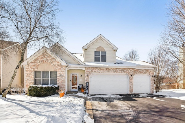 view of front facade featuring a garage, aphalt driveway, and brick siding