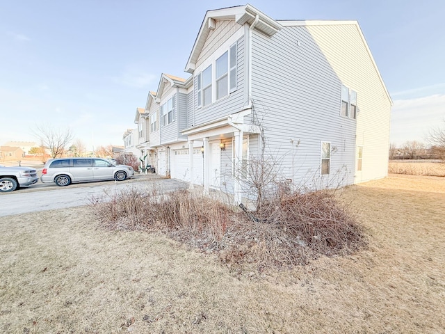 view of home's exterior with a garage and a yard