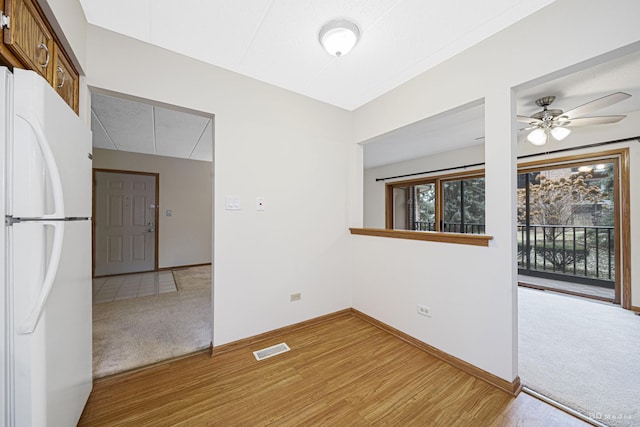 empty room featuring light carpet and ceiling fan