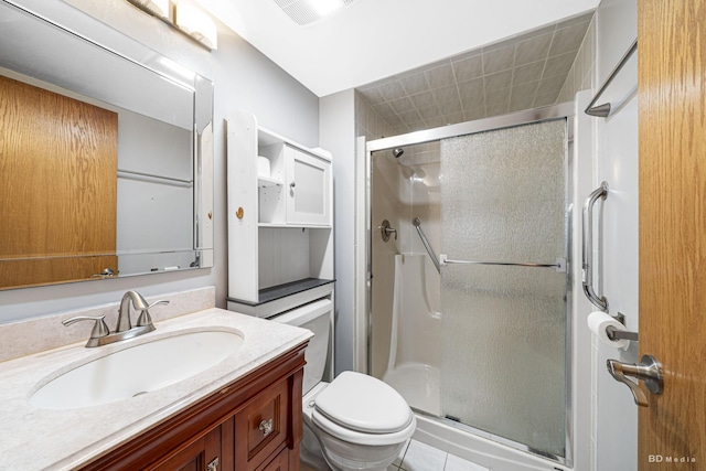 bathroom with an enclosed shower, vanity, and toilet