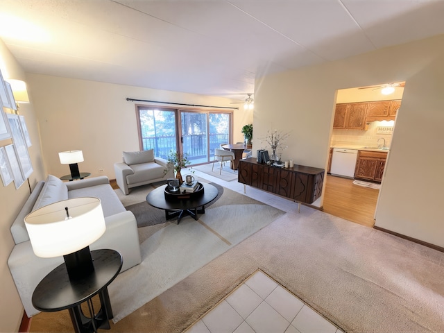 carpeted living room featuring sink and ceiling fan