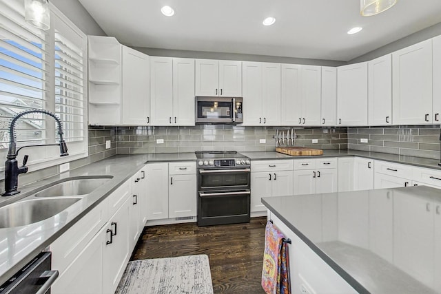 kitchen featuring open shelves, stainless steel appliances, dark wood-type flooring, white cabinets, and a sink