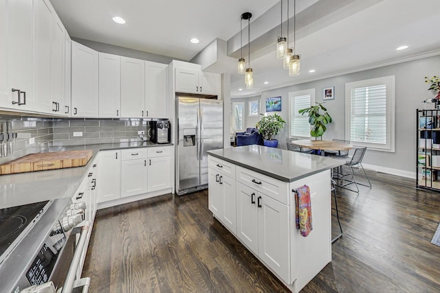 kitchen featuring tasteful backsplash, hanging light fixtures, stainless steel fridge with ice dispenser, and dark wood-style floors