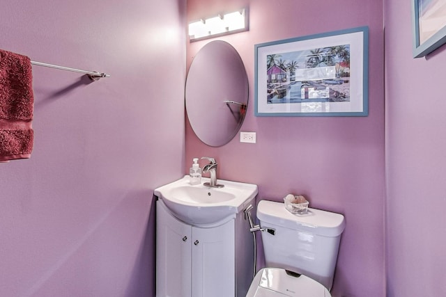 half bathroom featuring toilet and vanity