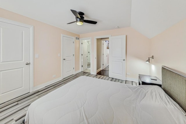 bedroom with ceiling fan, baseboards, and wood finished floors