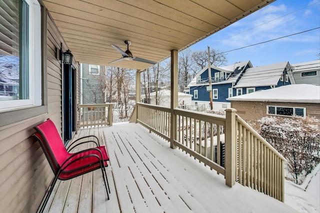 snow covered deck featuring a residential view and ceiling fan