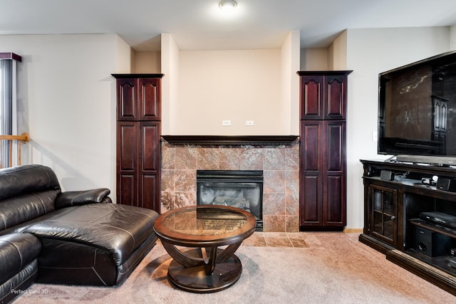 carpeted living room with a tiled fireplace