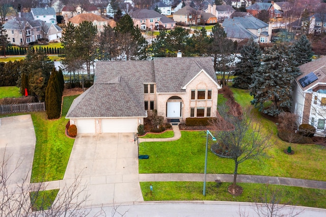 view of front of property featuring a garage and a front lawn