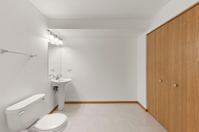 half bath with toilet and baseboards