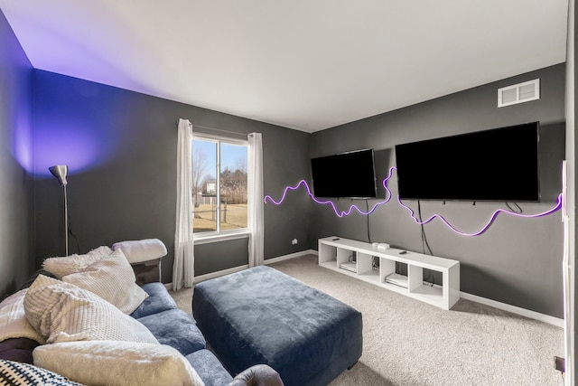 carpeted living area featuring visible vents and baseboards